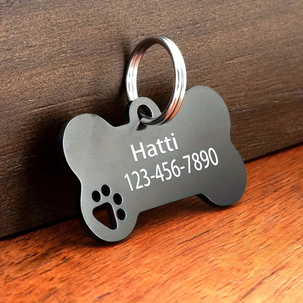 Bone-shaped engraved pet tag by Pawlio with name and phone number for dogs and cats, high-quality personalized pet identification.