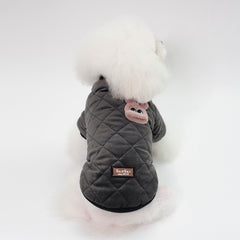 Small dog wearing a cozy plaid Pawlio jacket for autumn and winter, featuring warm fabric and stylish design.