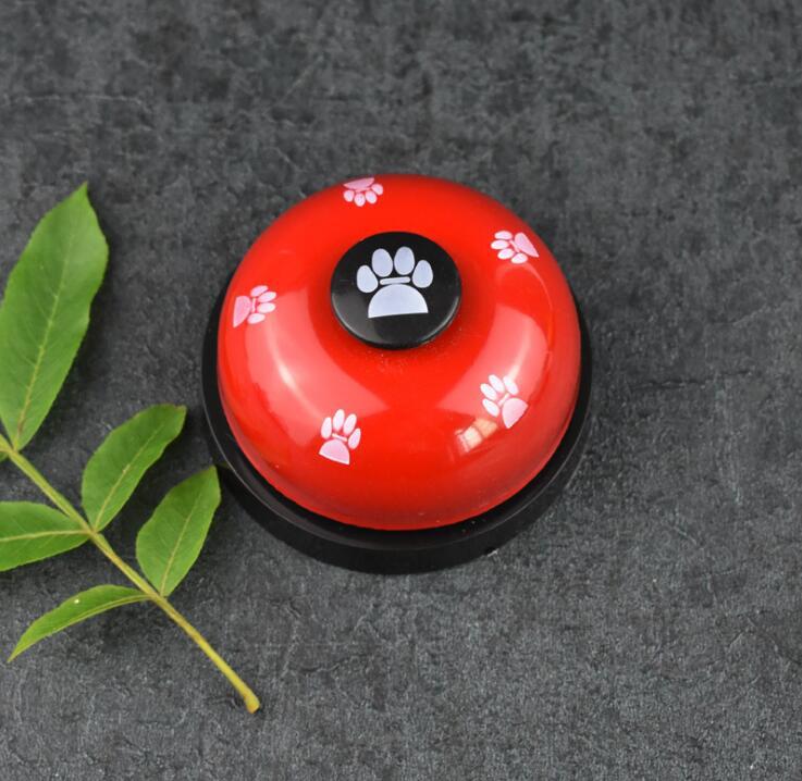 Pawlio Paw Press Training Bell with a wooden frame and metal bell for dog training and communication.