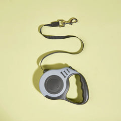 Pawlio™ Automatic Retractable Dog Leash with 3m and 5m durable nylon lead, featuring a sleek black handle and locking button.