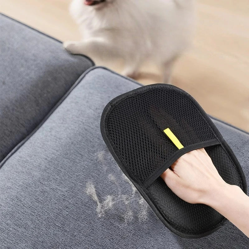 Pawlio™ Pet Hair Remover Grooming Glove showing a hand wearing the glove removing pet fur from a sofa surface.