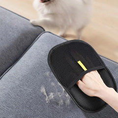 Pawlio™ Pet Hair Remover Grooming Glove showing a hand wearing the glove removing pet fur from a sofa surface.