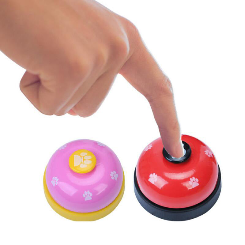 Pawlio Paw Press Training Bell with a polished metal surface and a colorful button, designed for dog training and communication.